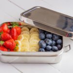 Stainless snack container with steel body and lid; thin silicone gasket visible under the lid